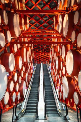 a staircase in a wine cellar with red barrels at East Sacred Hotel-Very close to the Drum Tower,The Lama Temple,Houhai Bar Street,Nanluoguxiang,Tiananmen Square and the Forbidden City, and the subway st ation is also very close in Beijing