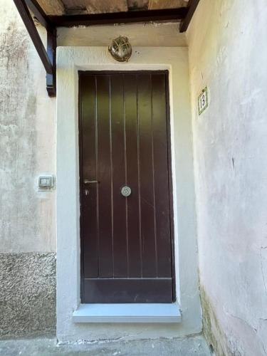 a brown door in the side of a building at Tender to Carafa in Capri