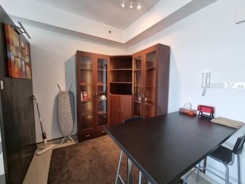 a dining room with a black table and chairs at Elite Homes at i-City - WiFi TV Box and 1 Carpark in Shah Alam