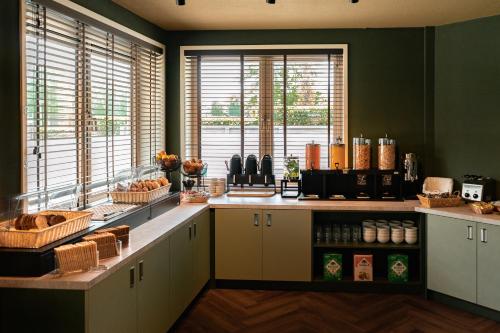 a kitchen with a counter with some food on it at Hotel het Zwaantje in Callantsoog