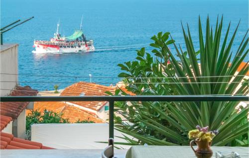 a large ship in the water with a boat at Beautiful Apartment In Podgora in Podgora