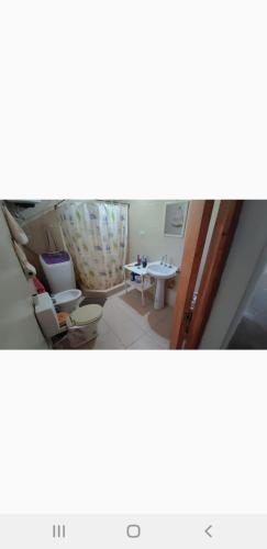 a small bathroom with a toilet and a table at Finca con pileta Lasmaria in Santiago del Estero