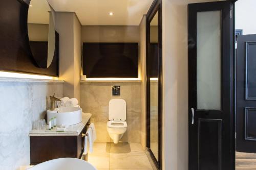 a bathroom with a toilet and a sink at Premier Hotel Cape Town in Cape Town