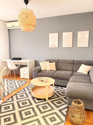 a living room with a couch and a table at Trip Style in Novi Sad