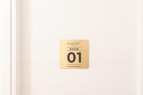 a sign that reads room oh on the door at Leonardo Da Vinci Guest House in Fiumicino
