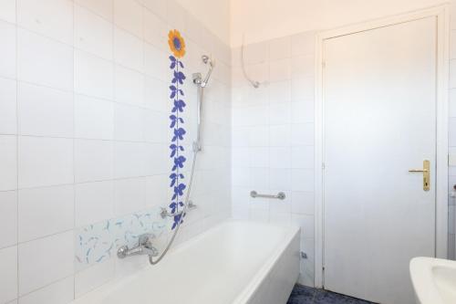 a white bathroom with a tub and a shower at Leonardo Da Vinci Guest House in Fiumicino