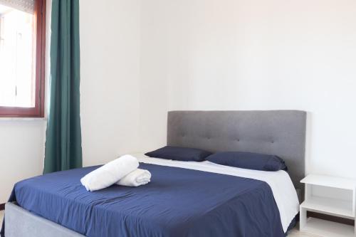 a bedroom with a bed with two pillows on it at Leonardo Da Vinci Guest House in Fiumicino