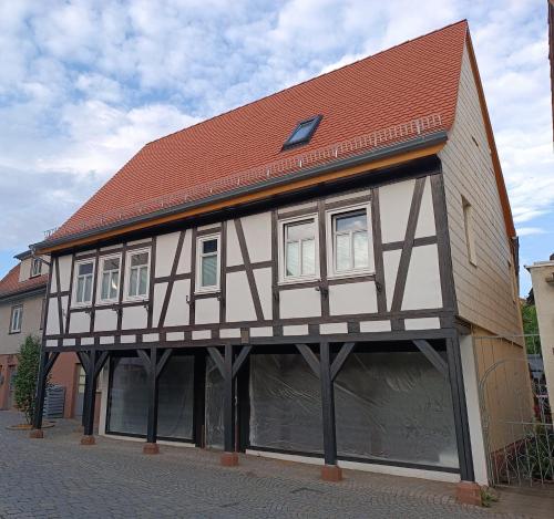 a half timbered building with a red roof at Ferienwohnung im Fachwerkhaus in Michelstadt