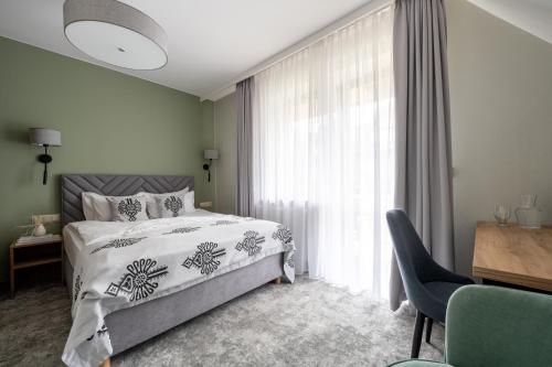 a bedroom with a bed and a window at Hotel Willa Pod Skocznią in Zakopane