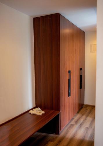 a wooden cabinet in a room with a wooden floor at The Mavvel Hotel in Kangaru