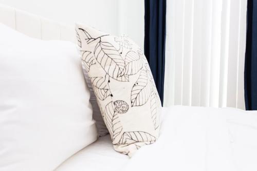 a pillow sitting on a bed next to a window at Lux Capitol Hill Vacation Home, In-House Services in Washington