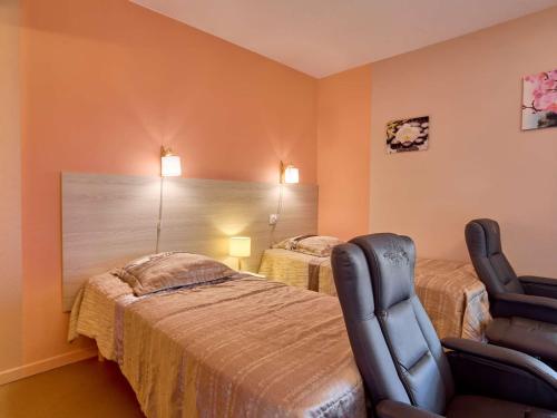 a bedroom with two beds and a chair in it at Studio lumineux proche Lac de l'Uby avec Wi-Fi gratuit - FR-1-841-55 in Barbotan-les-Thermes