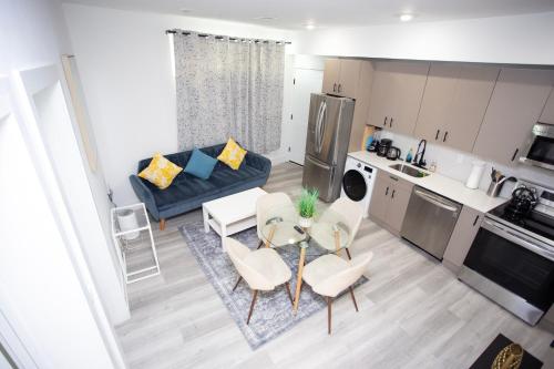 a living room with a couch and a table and chairs at Lux Capitol Hill Vacation Home, In-House Services in Washington
