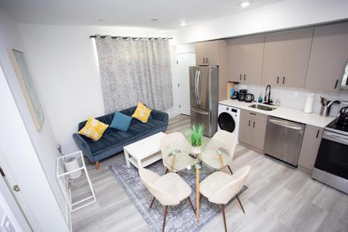 a kitchen and a living room with a table and chairs at Lux Capitol Hill Vacation Home, In-House Services in Washington