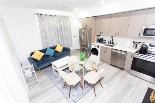 a kitchen and living room with a table and chairs at Lux Capitol Hill Vacation Home, In-House Services in Washington