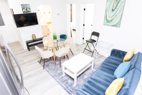 a living room with a blue couch and a table at Lux Capitol Hill Vacation Home, In-House Services in Washington