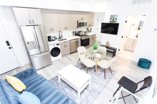 a living room with a blue couch and a table at Lux Capitol Hill Vacation Home, In-House Services in Washington