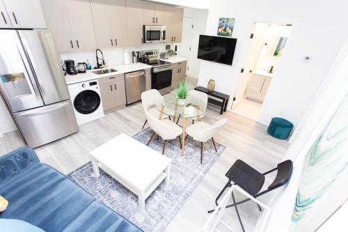 a kitchen and living room with a table and chairs at Lux Capitol Hill Vacation Home, In-House Services in Washington