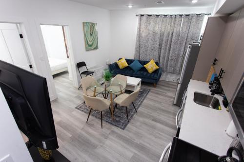 a living room with a table and a blue couch at Lux Capitol Hill Vacation Home, In-House Services in Washington