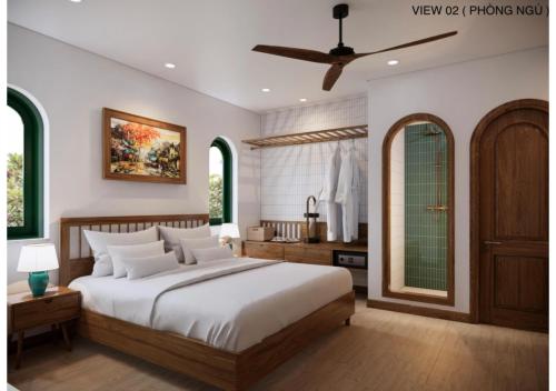 a bedroom with a large bed and a bathroom at Vang Anh Homestay Hoi An in Hoi An