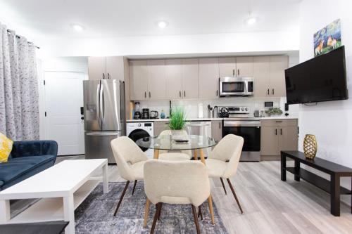 a kitchen and living room with a table and chairs at Lux Capitol Hill Vacation Home, In-House Services in Washington