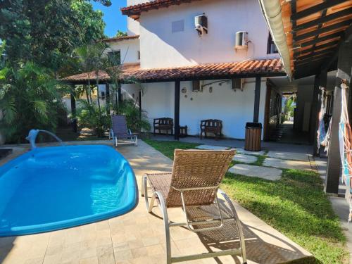 a patio with a chair and a swimming pool at Deck de Búzios in Búzios