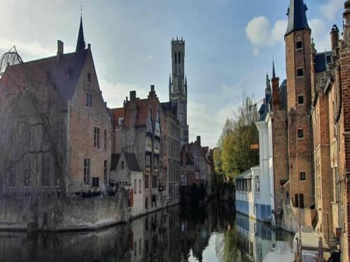 a view of a canal in a city with buildings at House in Zingem near Hiking Trails in Zingem