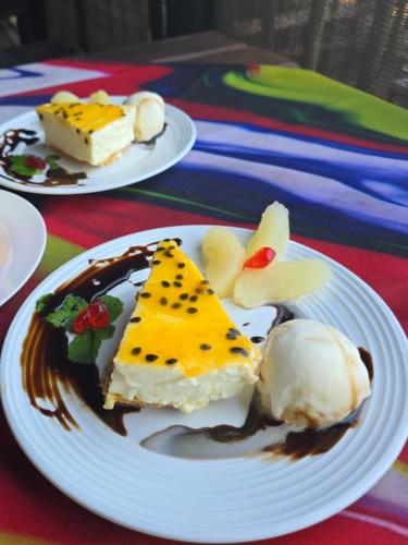 two plates of food on a table with ice cream at Sunrise Beach Lodge in Ponta Malongane