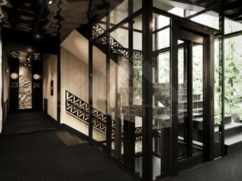 a hallway with glass windows and a staircase in a building at Apartament INCOGNITO PREMIUM & SPA in Białka Tatrzanska