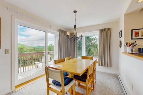 a dining room with a table and a large window at Snow Creek 115 in Warren