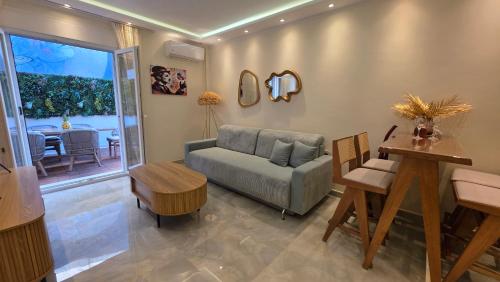 a living room with a couch and a table at Charlie Chaplin luxury apartments in Perea