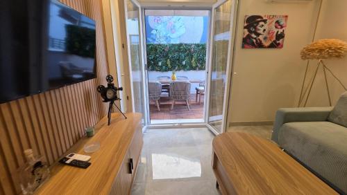 a living room with a couch and a television at Charlie Chaplin luxury apartments in Perea