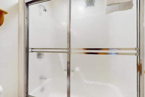 a shower with a glass door in a bathroom at Snow Creek 115 in Warren