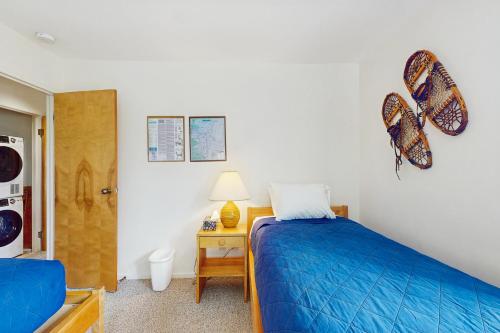 a bedroom with a bed and a table with a lamp at Snow Creek 115 in Warren