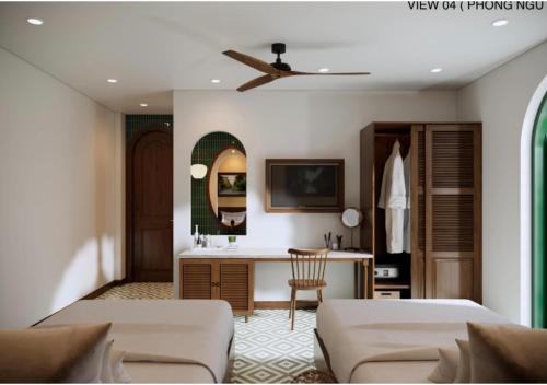 a hotel room with two beds and a desk at Vang Anh Homestay Hoi An in Hoi An