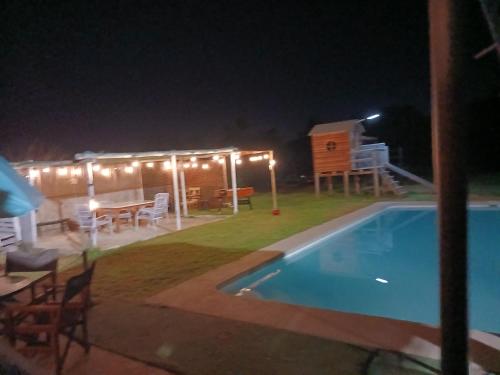 a backyard with a swimming pool at night at Rincon del Campo in La Serena