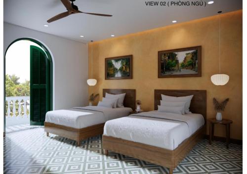 two beds in a room with two at Vang Anh Homestay Hoi An in Hoi An