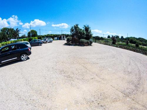 a gravel parking lot with cars parked on it at Villa Enli in Capalbio