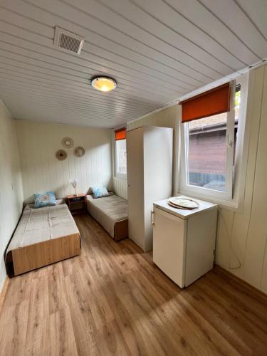 a small room with two beds and a window at Beach House Mrzeżyno in Mrzeżyno