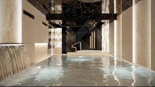 a swimming pool with a water feature in a building at Apartament INCOGNITO PREMIUM & SPA in Białka Tatrzanska
