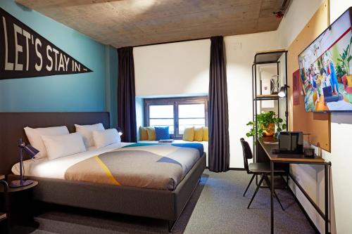 a bedroom with a bed and a desk with a computer at The Social Hub Madrid Extended Stay in Madrid