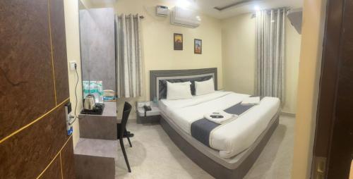 a bedroom with a large bed in a room at Dev Palace in Chennai