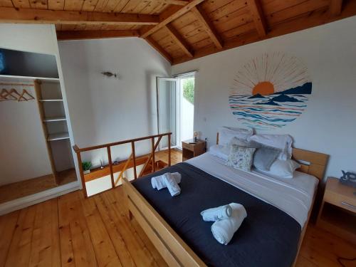 a bedroom with a bed with two towels on it at The White House Lumbarda in Lumbarda