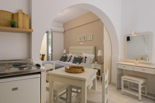 a kitchen and living room with a bed and a table at Scala Apartments in Kastraki Naxou