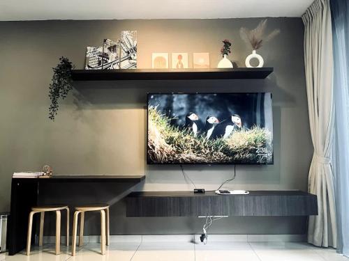 a flat screen tv sitting on top of a wall at Harmony Homes at i-City - free WiFi and 1 Car Park in Shah Alam