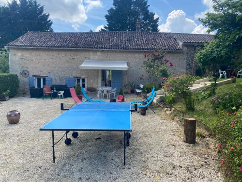 a ping pong table in front of a house at GITE LE PARC in Villamblard