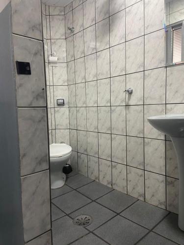 a bathroom with a shower and a toilet and a sink at Hotel Sany SP- Metrô Paulista in Sao Paulo