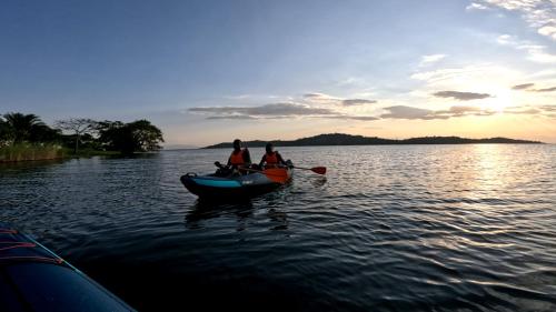 a group of people in a boat on a lake at Umutuzo Lodge Kivu Lake in Buhoro