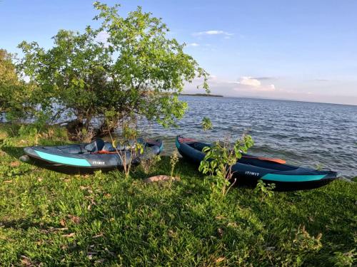 three kayaks parked on the shore of a lake at Umutuzo Lodge Kivu Lake in Buhoro
