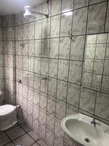 a bathroom with a sink and a toilet at Hotel Sany SP- Metrô Paulista in Sao Paulo